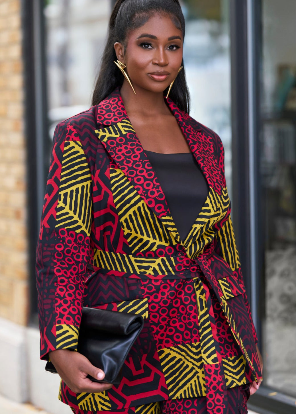 Woman wearing a colorful patterned suit outfit walking outdoors.