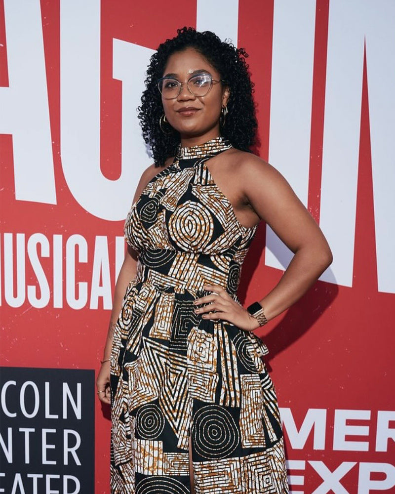 Three-quarter view of African print halter maxi dress showcasing a black, brown, and white geometric pattern on a model