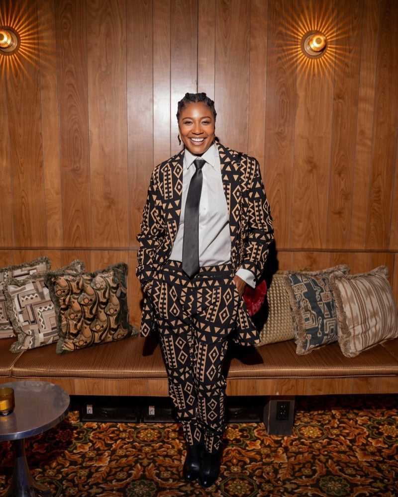 Front view of Uyai women’s tan and black tribal stretch blazer showcasing tribal print on a model indoors